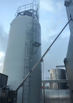 Transitube® auger conveyor carrying powdered food raw materials over a long distance from an outdoor silo. 