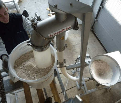 APIA Technologie technician carrying out an audit and repair on a flexible auger transfer system in an agri-food factory